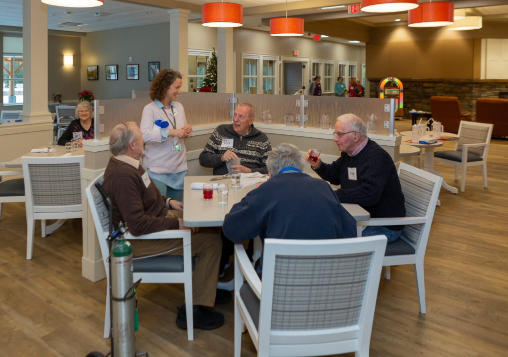 Group of seniors sitting at a table in the eating area