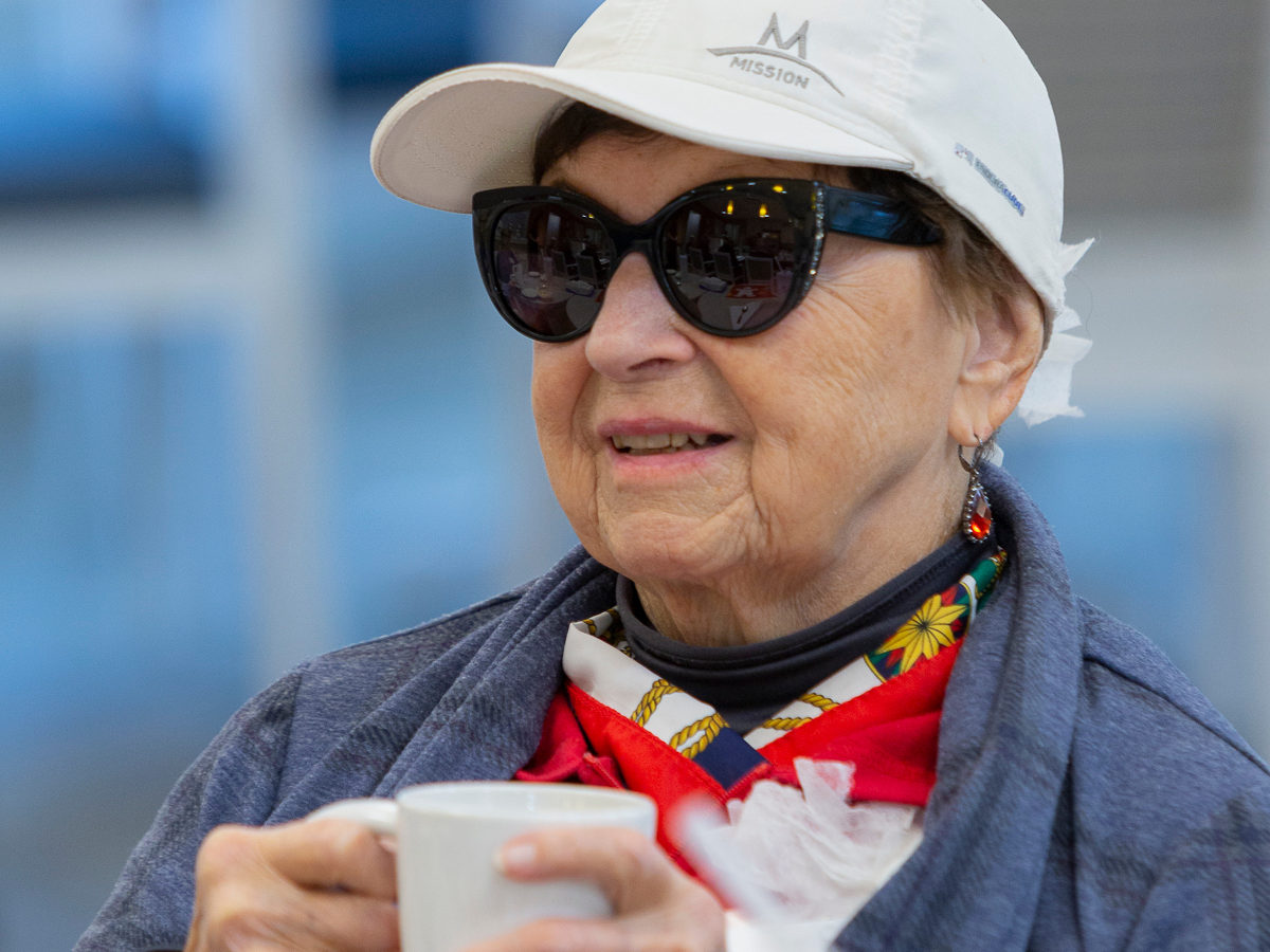 Woman smiling holding a coffee cup