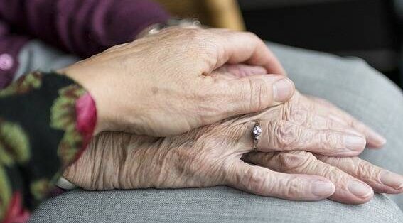 Hand holding an elder's hand